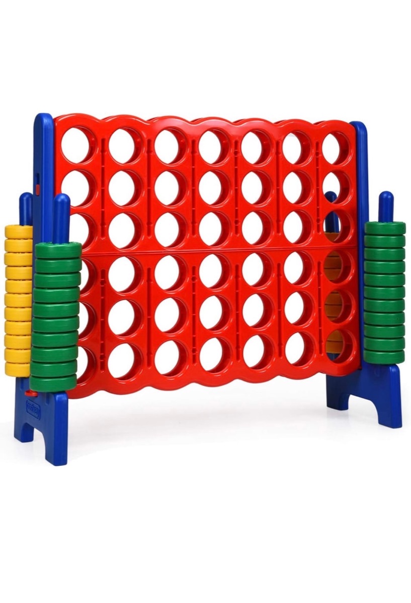 Giant Connect Four lawn game with red frame and stacks of yellow and green discs