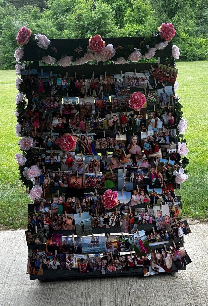 Rustic wooden pallet photo wall with peony florals and rows of photos clipped on with mini clothespins